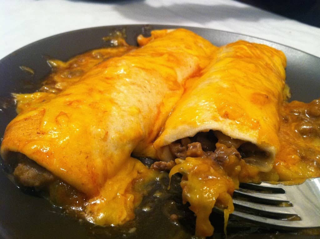 easy beefy enchiladas that are tasty and easy to make! Such a family pleaser! www.busybudgeter.com