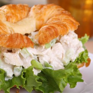 Closeup of a chicken salad and lettuce on a croissant roll