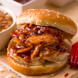 Pulled pork with barbecue sauce and a sesame seed bun with a side of baked beans as one of the easy dinners in the easiest Aldi meal plan, which delivers 14 dinners to your front door for under $150.