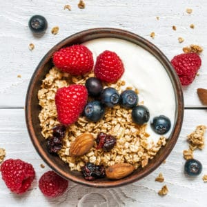 Yogurt with blueberries, granola, raspberries and dried cranberries as one of the easy dinners in the easiest Aldi meal plan, which delivers 14 dinners to your front door for under $150. 