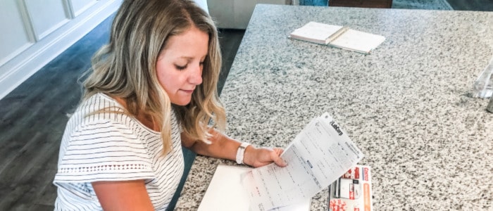 Woman creates budget and adds in medical bills as she implements her home management system. 