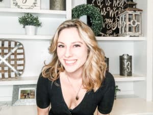 Blond woman smiling in front of book case during a fun girls night in