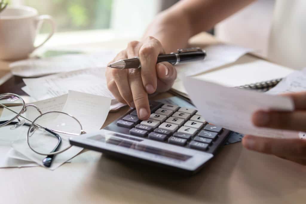 young woman calculating and paying bills.