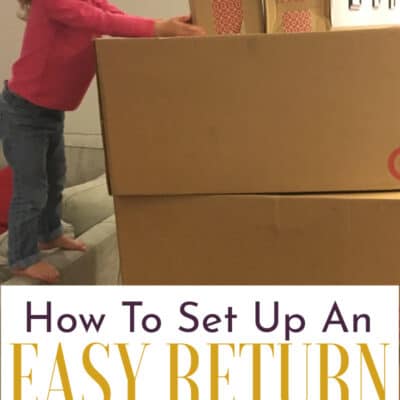 Young girl standing on a couch next to large cardboard boxes that need to be returned.