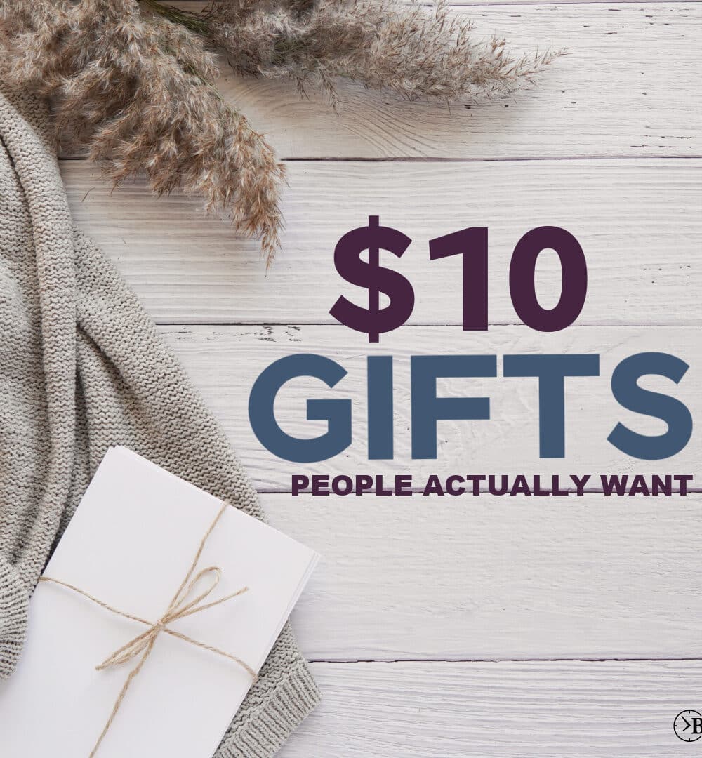 WHITE PLANK WOOD WITH NUETRAL COMFY SWEATER, AND TWINE WRAPPED GIFT WITHT HE WORDS " $10 GIFTS PEOPLE ACTUALLY WANT"