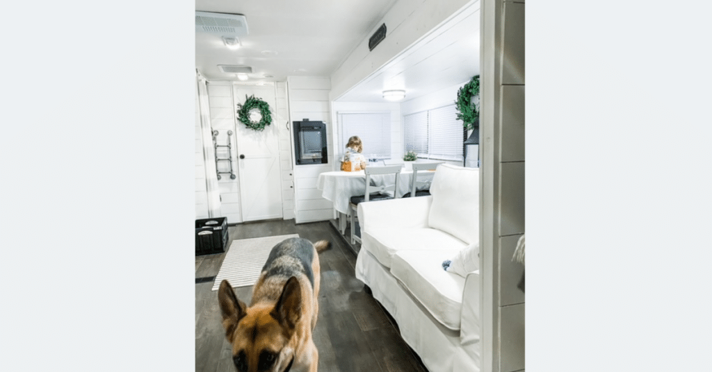 WHITE RENOVATRED CAMPER WITH A GERMAN SHEPARD