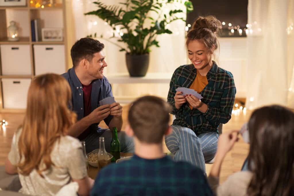 5 people playing family game night at home.