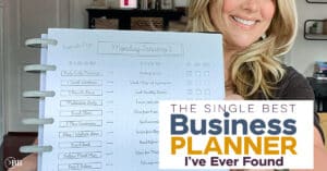 Blonde woman holding up a business planner with a blue, yellow, and purple graphic that says "The Single Best Business Planner I've Ever Found."